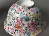 a vase with flowers painted on it sitting on a table