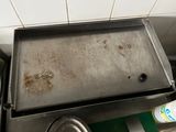 a metal pan sitting on top of a stove in a kitchen