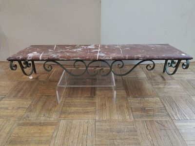a marble table with a metal base on a wooden floor