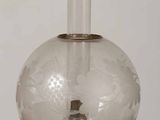 a glass lamp that is sitting on a table