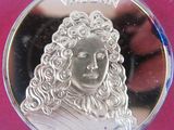 a close up of a coin with a woman ' s face on it