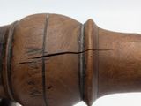 a close up of a wooden object on a white surface