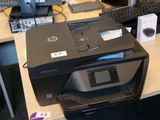 une imprimante posée sur un bureau, à côté d'un clavier
