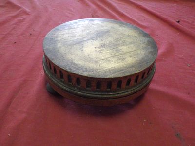 a small wooden object on a red cloth