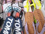 many pairs of flip flops that are lined up on a table