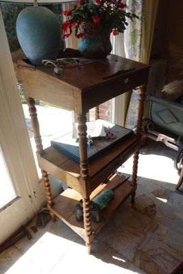 a table with books and a vase on top of it