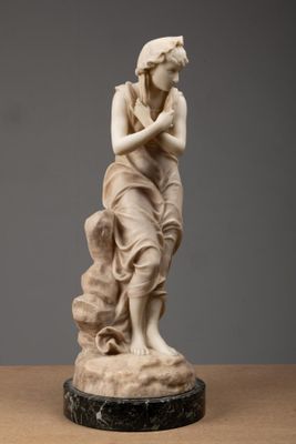 a white marble statue of a woman holding a bird on top of a table