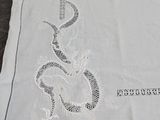 a white table cloth with a picture of a dragon on it