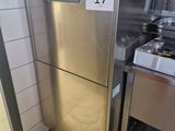 a stainless steel refrigerator in a kitchen with a number on the door