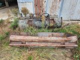 a rusted out bench in front of a rusty building