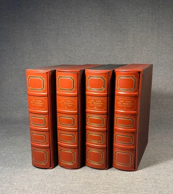 three red books sitting on top of each other on a gray surface