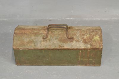 an old metal tool box sitting on the floor