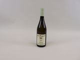 a bottle of wine sitting on top of a white table