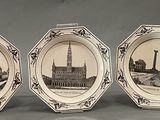 three plates with a picture of a building and a clock on them