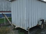 an image of a trailer that is parked in front of a building