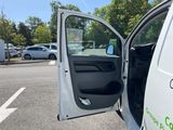 a white van with the door open in a parking lot