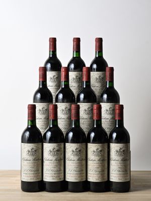 a bunch of bottles of wine sitting on top of a wooden table