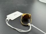 a ring with a tag attached to it sitting on a table