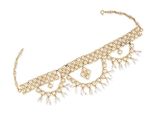 a close up of a gold necklace with pearls on a white background