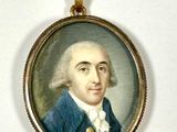 portrait of a man wearing a blue coat and white shirt