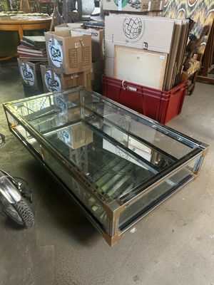 une table basse avec un plateau en verre dans une pièce