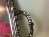 a silver tray with a mirror on it on a table