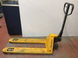 the forklift is sitting on the floor next to the wall
