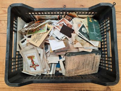 a basket full of old books on a wooden table
