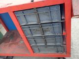 a red and blue cart with a blue door on it