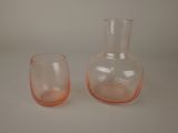 two glass vases sitting next to each other on a table