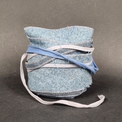 a blue bag with a blue ribbon wrapped around it