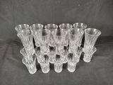 six clear glass vases sitting on top of a black cloth