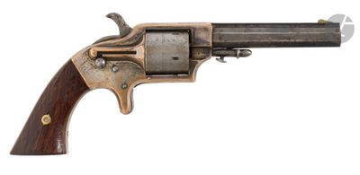 an old revolver with a wooden handle on a white background