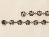 three silver bracelets with black and white stones on a white surface