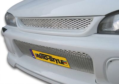the front of a white car with a yellow license plate on it