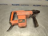 a close up of an electric drill on a metal surface