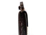 leather case with a lighter in it sitting on a white surface