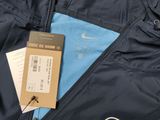 nike windbreaker jacket in blue with a tag on it
