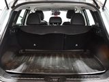 the back end of a silver car with the trunk open