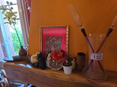 a picture of a vase on a shelf with a picture on it