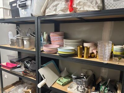 many plates and cups on the shelves in the room