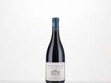 a bottle of red wine sitting on top of a table