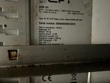 a picture of a metal shelf with a sign on it