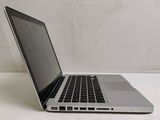 a silver laptop computer sitting on a white table
