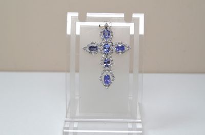 clear acrylic cross with blue and white stones on display