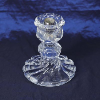 clear glass candle holder on a blue background
