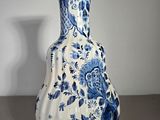 a blue and white vase sitting on a table