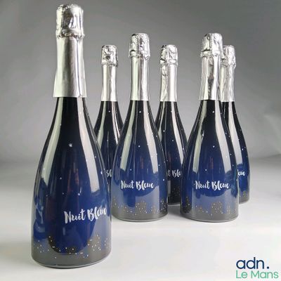 six bottles of blue wine are lined up in a row