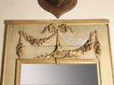 a mirror with a gold frame and a deer head on the wall