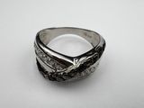 a close up of a ring on a table with a white background